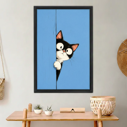 Peeking tuxedo cat framed canvas wall art print on blue background above wooden desk