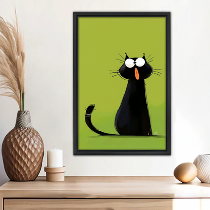 Funny wide-eyed black cat sticking out tongue green background wall art print in black frame above wooden sideboard with pampas grass vase and white candle in boho entryway