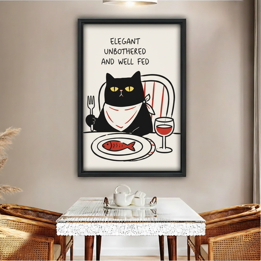 Elegant unbothered and well fed black cat dining fish wine funny wall art print in black frame above glass dining table with rattan chairs and white tea set in boho dining room