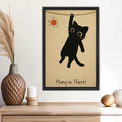 Funny hang in there black cat hanging on rope vintage motivational wall art print in black frame above wooden sideboard with pampas grass vase and white candle in boho entryway