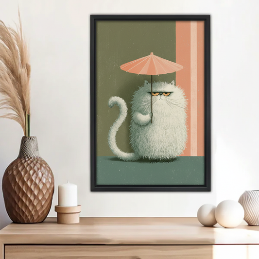 Grumpy fluffy white cat holding pink umbrella wall art print in black frame above wooden sideboard with pampas grass vase and white candle in boho entryway