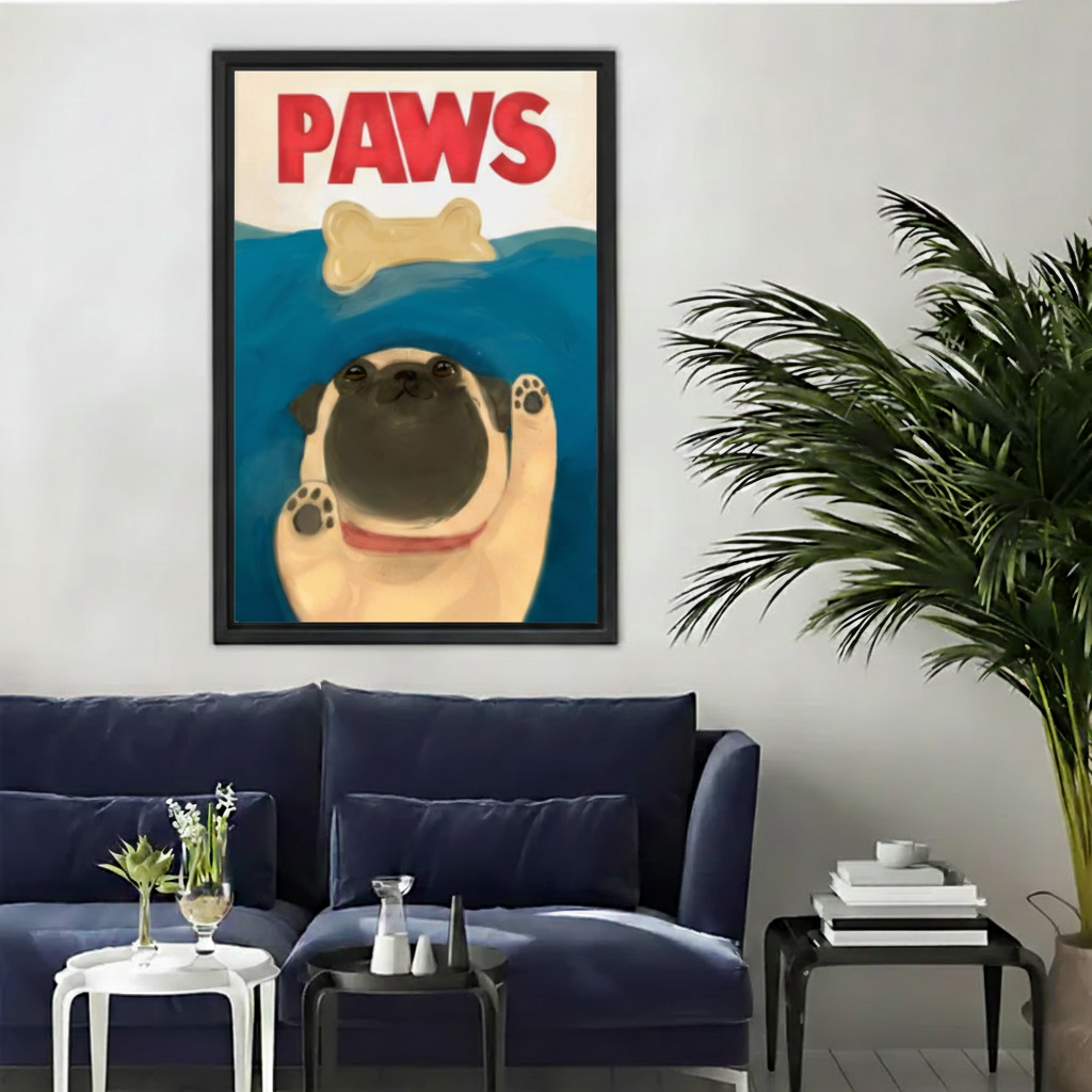 Funny pug dog PAWS Jaws movie parody swimming bone wall art print in black frame above navy velvet sofa with white side table and black coffee table in modern living room