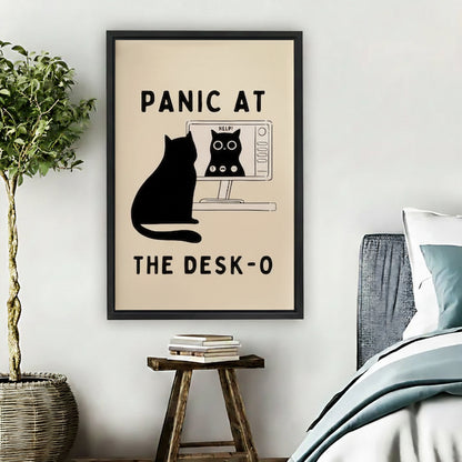 Funny black cat panic at the desk-o computer screen humorous wall art print in black frame above wooden stool with stacked books and wicker basket in boho bedroom