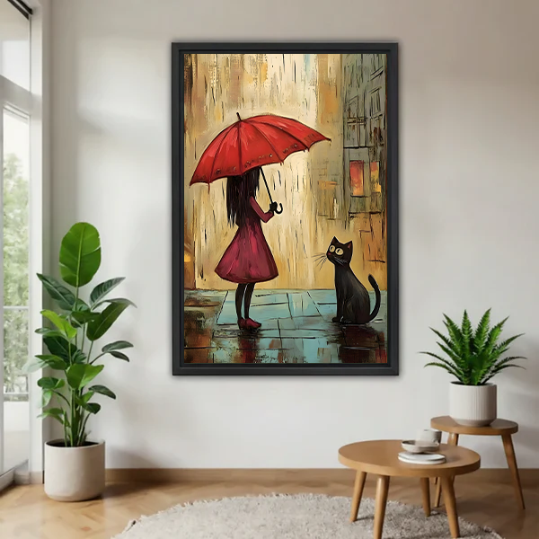 Whimsical red umbrella girl and black cat canvas wall art in a black frame beside leafy plants.