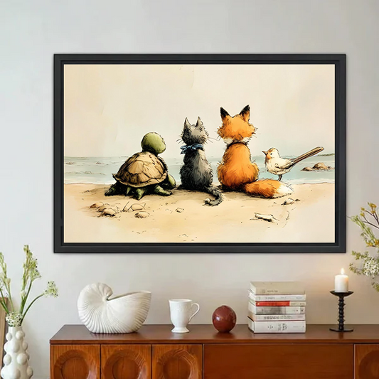 Turtle gray cat orange fox and small bird sitting side by side on sandy beach facing the ocean vintage illustration style framed wall art hung on white wall above mid-century modern wooden sideboard with white ceramic vase dried flowers white mug and black candlestick holder
