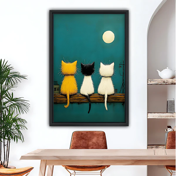 Three cats watching moon teal night sky framed canvas wall art above dining table