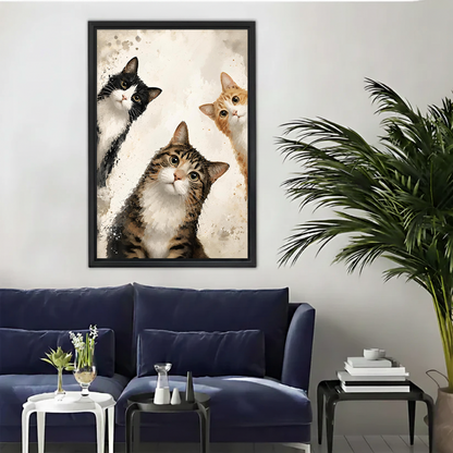Framed whimsical watercolor cat portrait wall art print in black frame above a blue sofa
