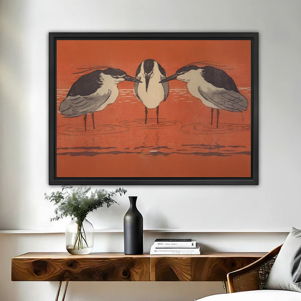 Framed Japanese woodblock three herons rust red wall art print above wooden console table with vase
