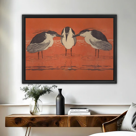 Framed Japanese woodblock three herons rust red wall art print above wooden console table with vase