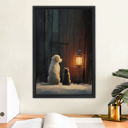 Dog and cat sitting by glowing lantern in snow night oil painting framed wall art hung above wooden desk with gold mug and plant in home office
