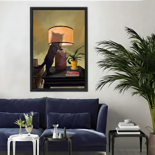 Vintage black cat lamp framed wall art print with warm golden tones above navy sofa in modern living room