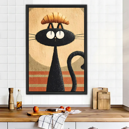 Funny black cat croissant retro framed wall art in black frame above rustic wooden kitchen counter