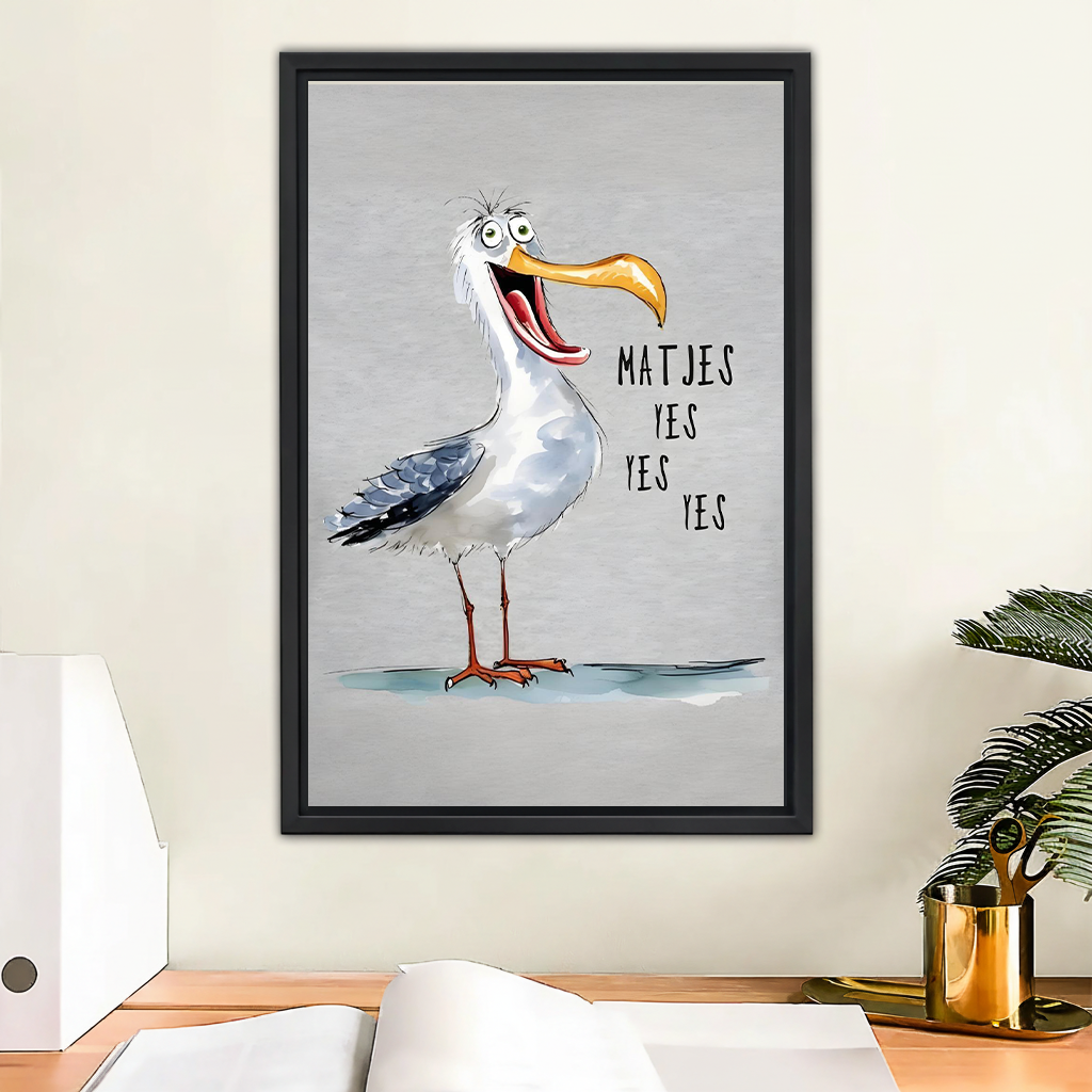 Funny seagull coastal wall art print in black frame above wooden desk – 'Matjes Yes Yes Yes' humorous bird illustration on grey background for home office decor