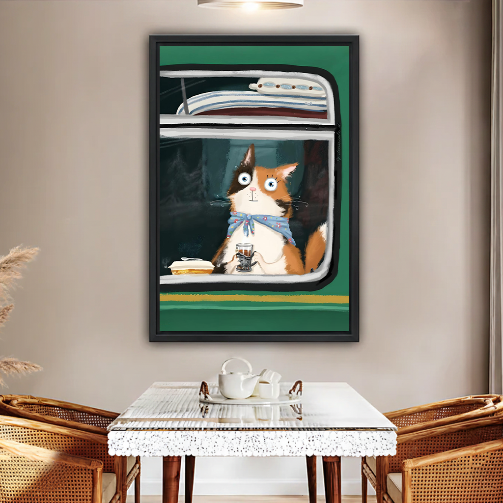 Framed whimsical cat on train wall art print hanging in a cozy dining room with rattan chairs