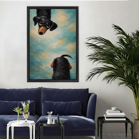 Black framed dachshund dog wall art with dreamy blue sky background above cream armchair