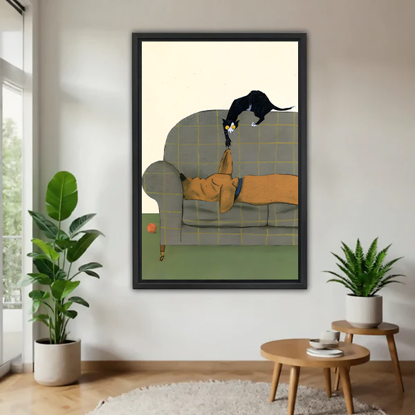 Framed cat and dog wall art print hanging in a bright living room with indoor plants, whimsical illustrated pet decor