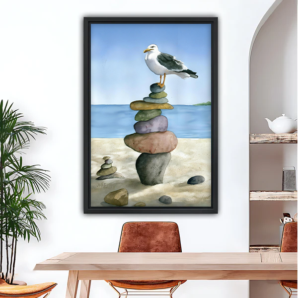 Coastal seagull on stacked stones framed canvas wall art in black frame, watercolor beach scene for dining room decor