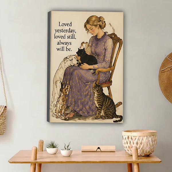 Woman in lavender floral dress sitting on wooden chair holding black cat with white long-haired dog beagle and tabby cat beside her vintage watercolor illustration with loved yesterday loved still always will be quote gallery wrap canvas art displayed on white wall above wooden desk with succulent white bowl and wicker basket