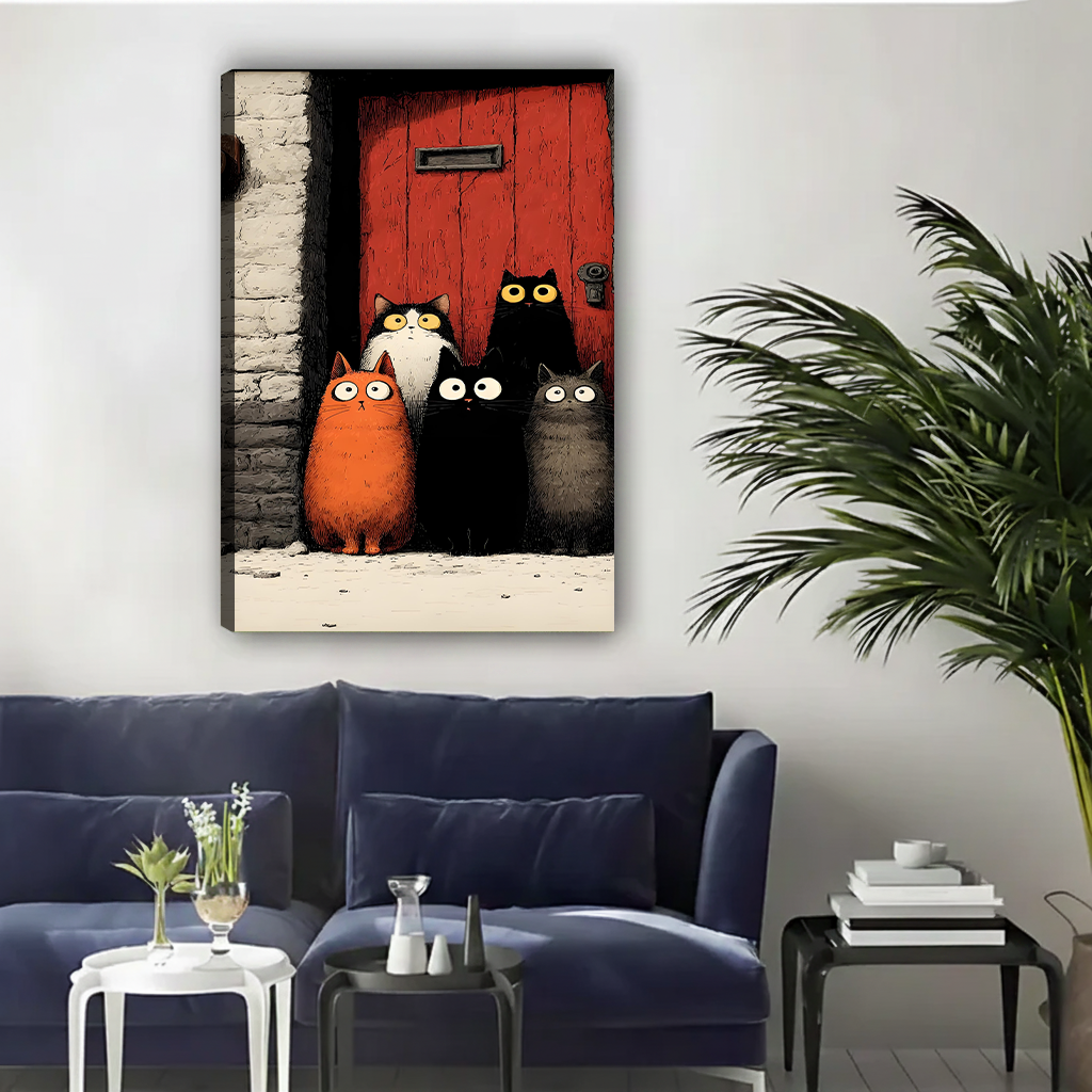 Five wide-eyed cartoon cats orange black-white small black large black and grey gathered at red wooden door gothic illustration gallery wrap canvas art displayed on white wall above navy blue sofa with white side tables and palm plant