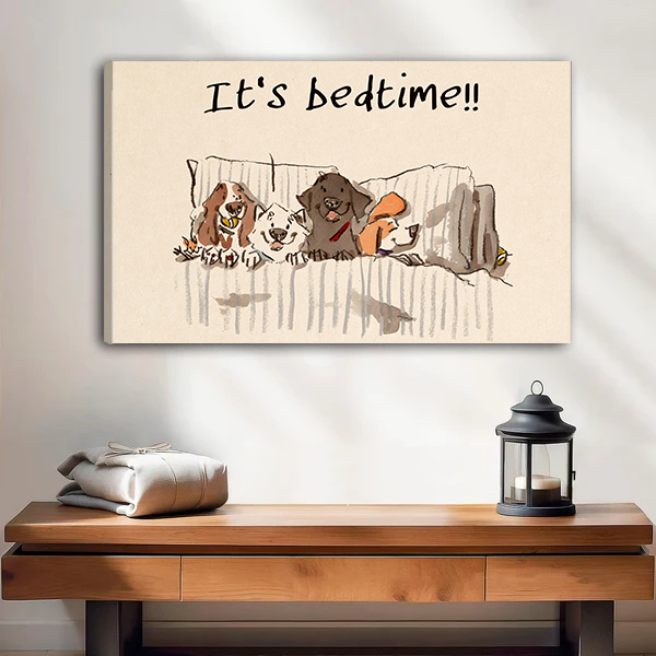 Four dogs piled in bed It's Bedtime funny whimsical gallery wrap canvas art without frame hanging above wooden console table with lantern and folded linen