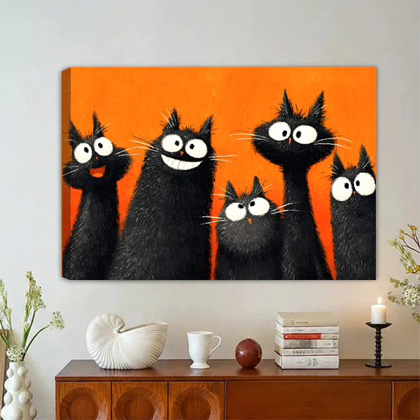 Five fluffy black cats with big white eyes laughing and staring on bold orange background pop art oil painting style gallery wrap canvas art displayed on grey wall above vintage walnut sideboard with white ceramic decor stacked books and black candle holder