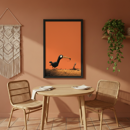 Funny black bird and worm face off orange background cartoon wall art print in black frame on terracotta wall above rattan dining chairs with macrame wall hanging in boho dining room