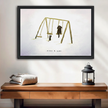 Cat and dog on swing set "Highs & Lows" framed wall art print, black frame, whimsical minimalist illustration, displayed above a wooden console table in a warm neutral entryway