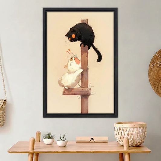 Funny black cat spooking white cat on wooden post Japanese illustration wall art print in black frame above wooden console table with white succulents and wicker basket in boho entryway