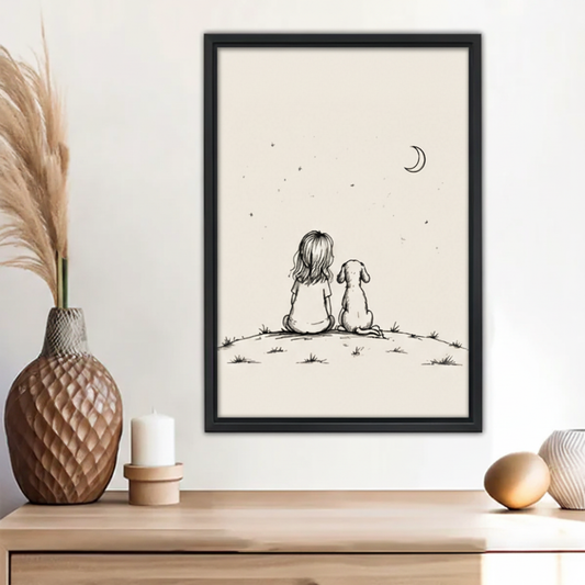 Minimalist girl and dog sitting on hill watching moon stars line drawing wall art print in black frame above wooden sideboard with pineapple vase and white candle in boho living room