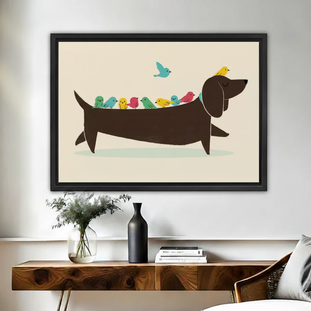 Funny dachshund with colorful birds on back wall art print in black frame above rustic wood console table with black vase and eucalyptus in modern entryway