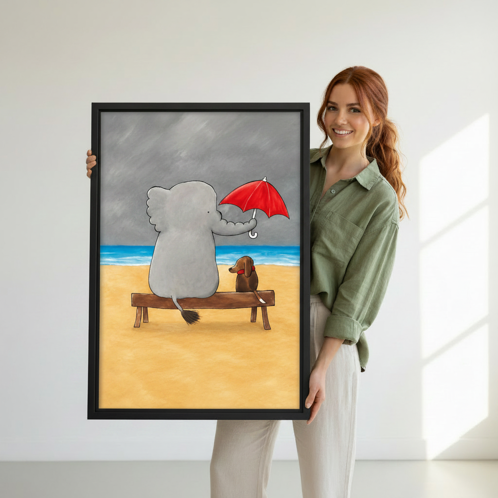 Woman holding large framed elephant and dachshund sitting on beach bench with red umbrella wall art print, black frame, whimsical cartoon friendship illustration grey stormy sky, showing actual print size in a bright modern studio