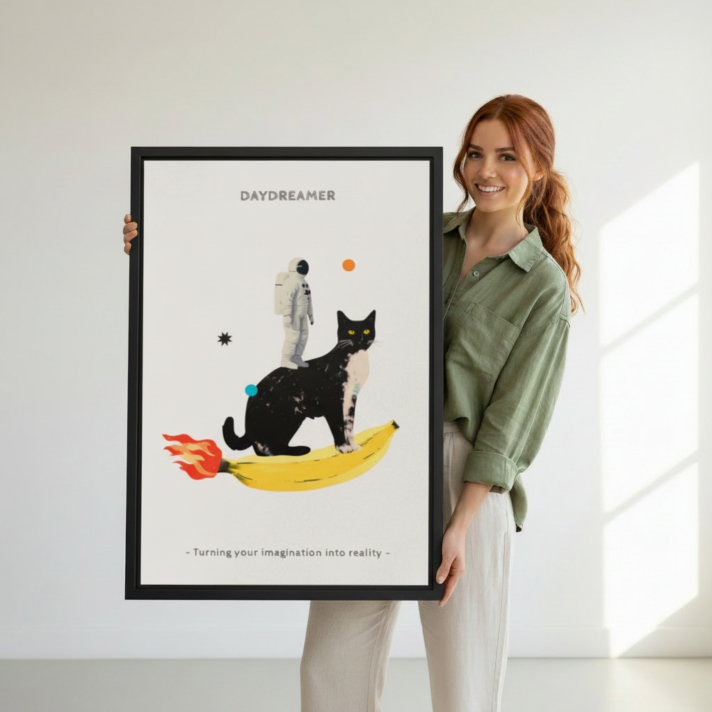 Woman holding large framed daydreamer black cat riding banana rocket astronaut collage wall art print in black frame showing actual print size in bright white studio