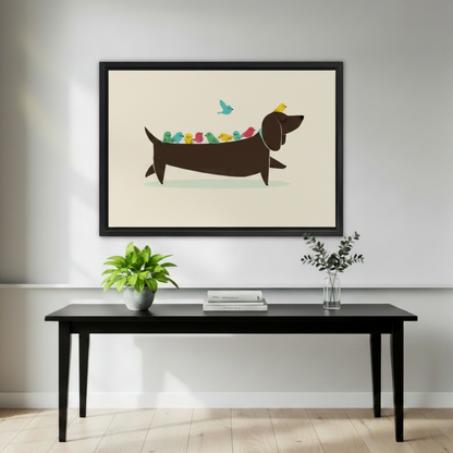 Cute dachshund with colorful birds perched on back wall art print in black frame above black console table with green plant and eucalyptus vase in minimalist living room