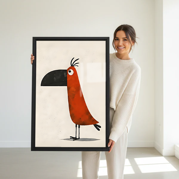 Woman holding a large framed whimsical toucan minimalist wall art print in a bright white studio