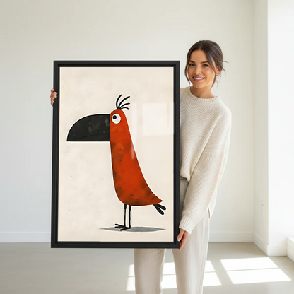Woman holding a large framed whimsical toucan minimalist wall art print in a bright white studio