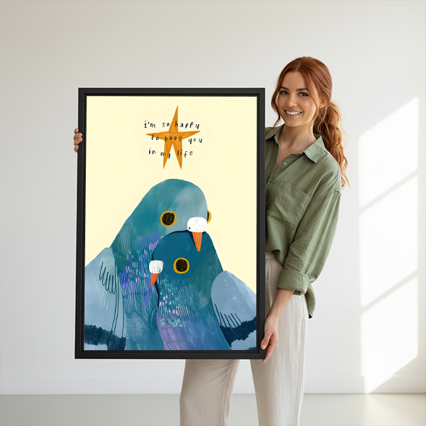 Woman holding large love birds whimsical framed canvas print with I'm so happy to have you quote showing size reference in bright white studio