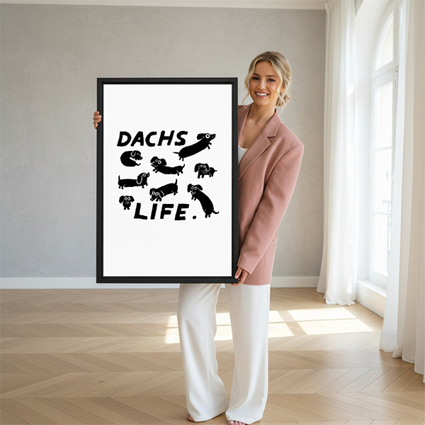 Woman holding Dachs Life black and white dachshund framed art print in bright modern room