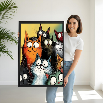 Funny cartoon cats canvas wall art in black frame held by woman – colorful big-eyed cat print for living room