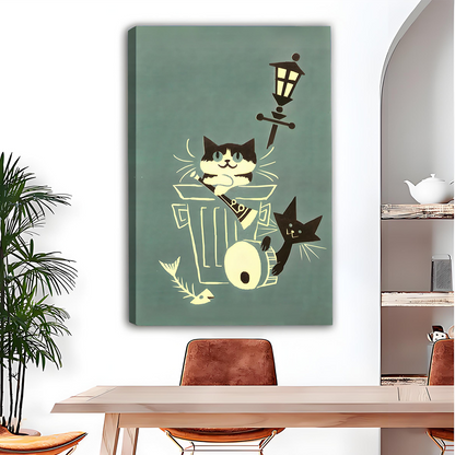 Black-framed alley cats canvas wall art on sage green displayed above a gray sofa with blue and white cushions.