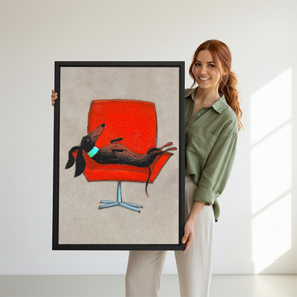 Woman holding large dachshund on red mid-century chair framed canvas print showing size reference in bright white studio
