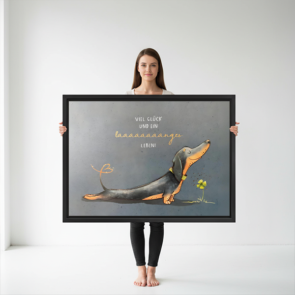 Woman holding large funny dachshund framed canvas print showing size reference