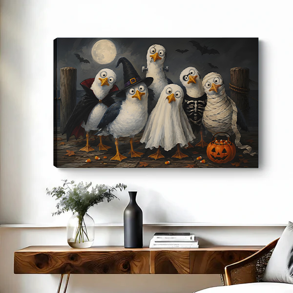 Whimsical Halloween birds canvas wall art in a black frame above a bed with white pillows.