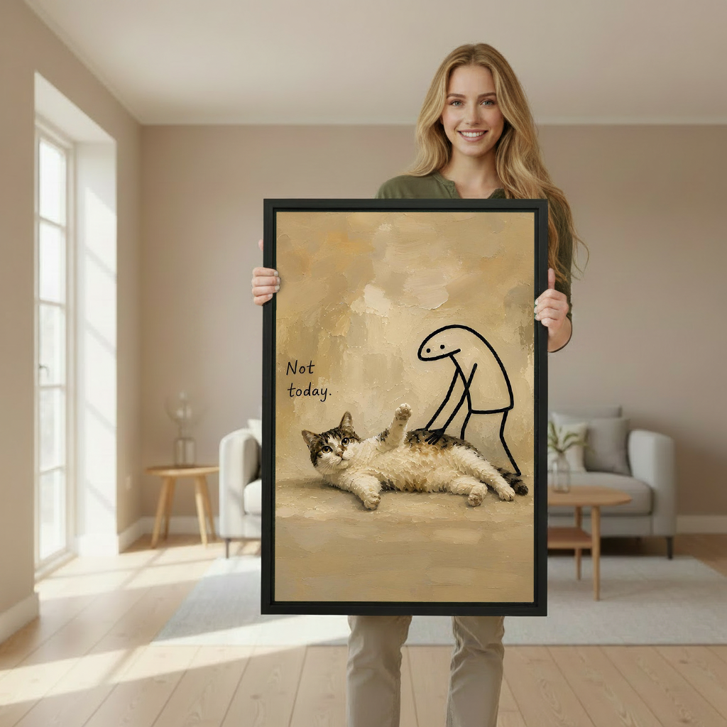 Woman holding a large framed 'Not Today' whimsical cat oil painting wall art print in a bright neutral living room