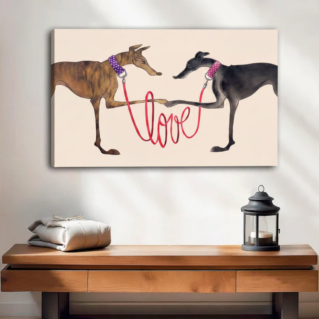 Two greyhounds with red love leash canvas wall art, frameless gallery wrap, whimsical dog love illustration cream background, hung above a wooden console table with lantern in a bright minimalist entryway