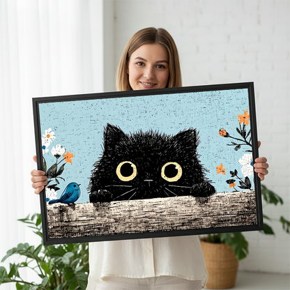 Woman smiling and holding large fluffy black cat peeking vintage floral framed canvas print with yellow eyes and blue bird in bright white studio with green plants
