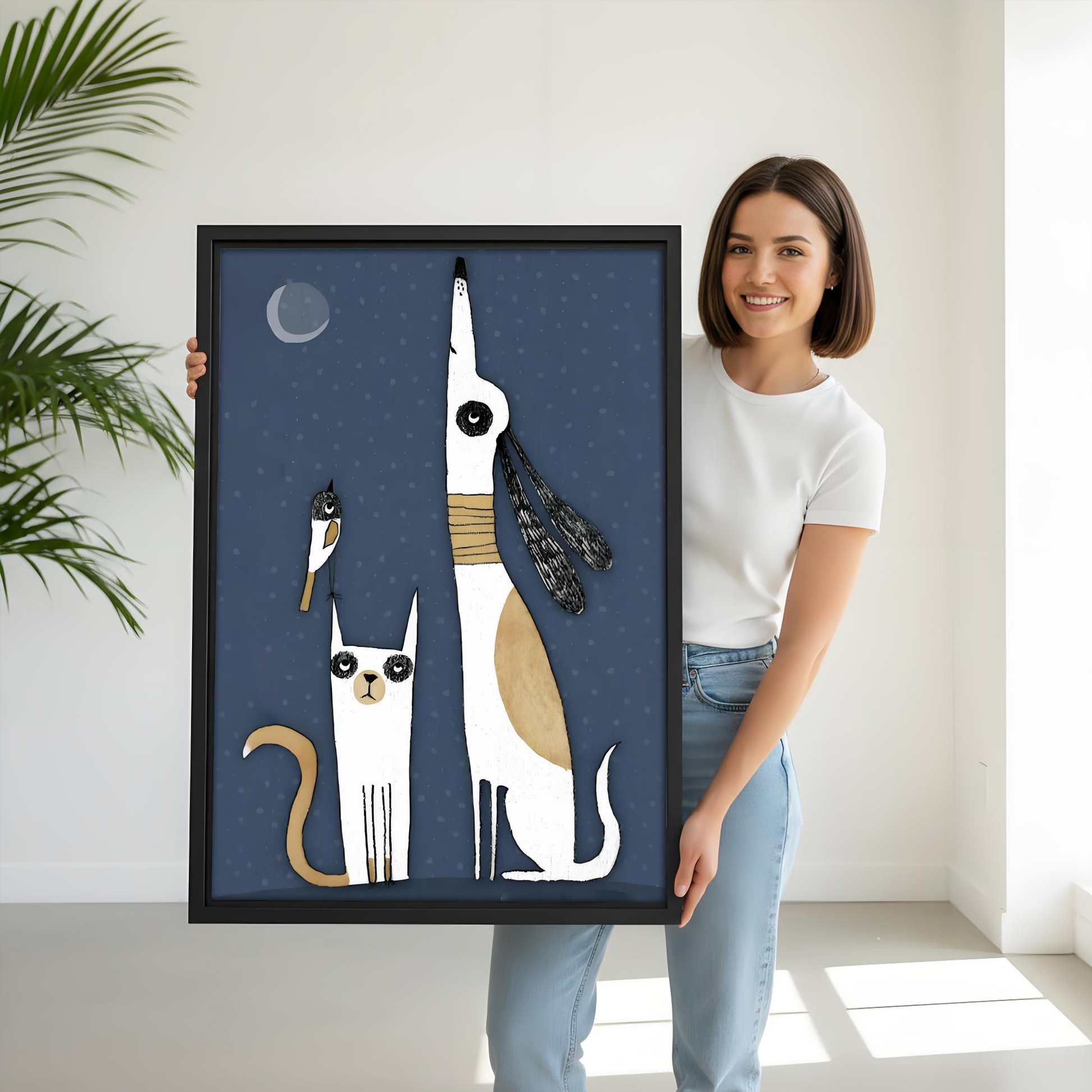 Woman holding large whimsical cat dog moon framed canvas print, black frame, midnight blue animal wall art, size reference lifestyle photo