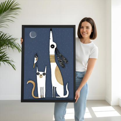 Woman holding large whimsical cat dog moon framed canvas print, black frame, midnight blue animal wall art, size reference lifestyle photo
