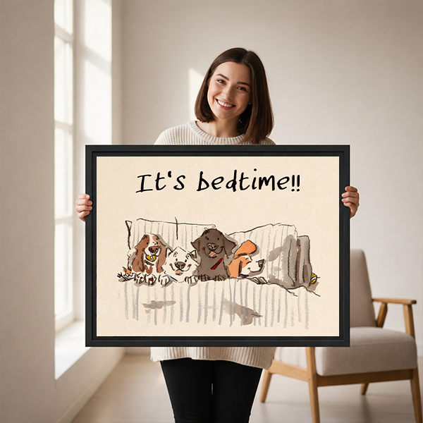 Woman holding large It's Bedtime dogs in bed funny whimsical framed canvas print showing size reference in bright studio with wooden chair