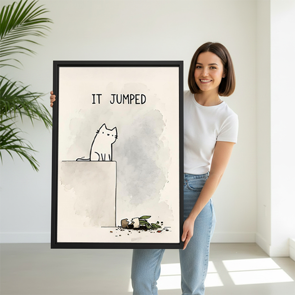 Smiling woman holding large funny cat It Jumped minimalist line art framed canvas print to show size in bright white room with palm plant