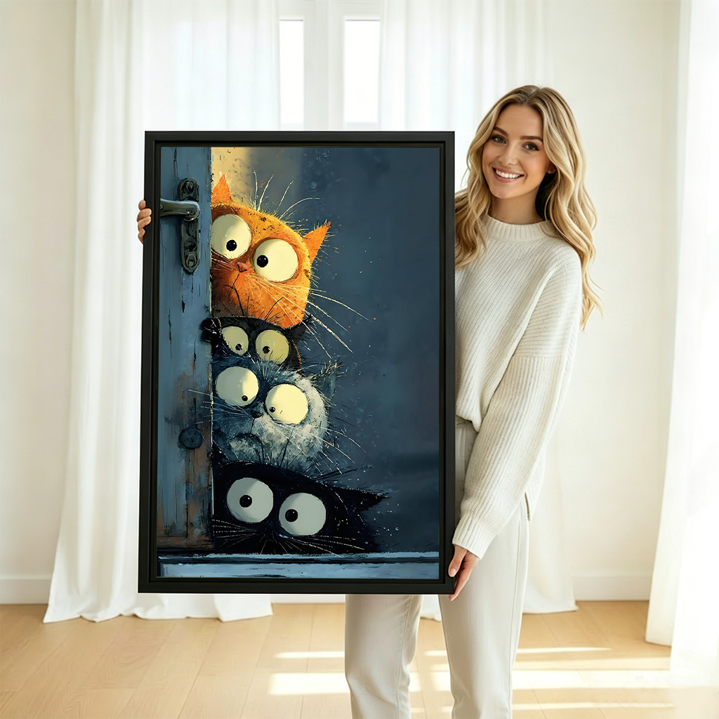 Smiling blonde woman in cream knit sweater holding large four cats peeking door funny whimsical oil painting framed canvas print with orange black grey and black cats stacked around vintage blue door in bright white room with sheer curtains and natural light